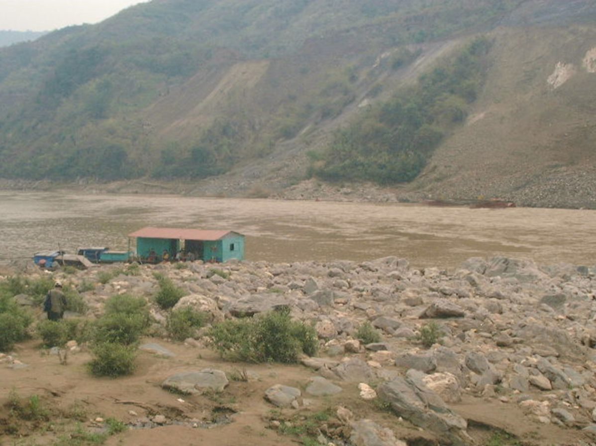 Rocky, scoured riverbank downstream of a dam.